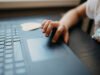 Auto-Generate PDFs in Make Child interacting with a laptop touchpad while sitting at a table