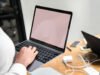 Webflow Pricing Plans Explained Woman using a laptop in a meeting