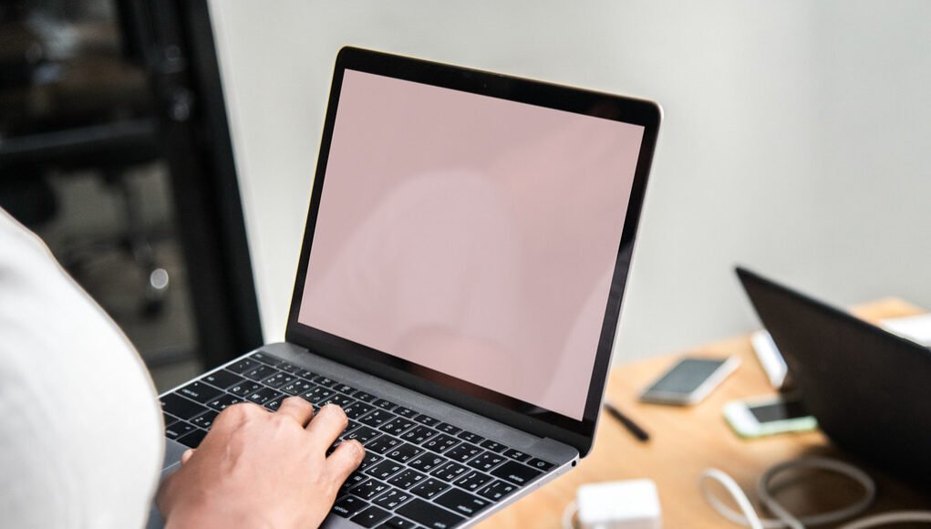 Woman using a laptop in a meeting