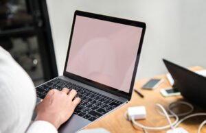 Webflow Pricing Plans Explained Woman using a laptop in a meeting