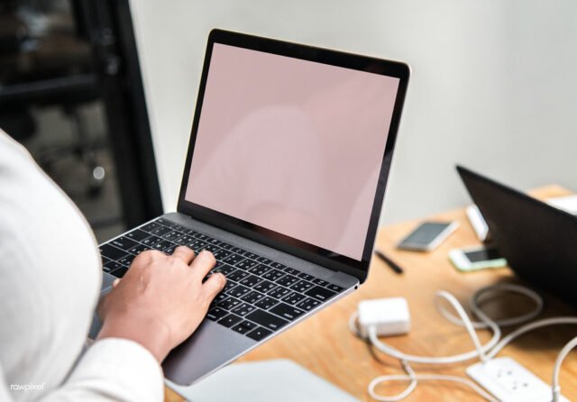 Webflow Pricing Plans Explained Woman using a laptop in a meeting